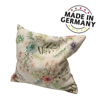 Decorative cushion with floral pattern, text 'Made in Germany' with stars in black, red and yellow.