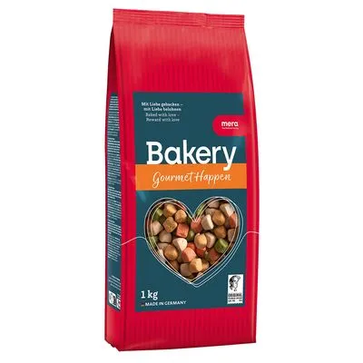 Zak mera Bakery GourmetHappen, 1 kg, zichtbare gekleurde brokjes in hartvormig venster. Tekst: 'Mit Liebe gebacken – mit Liebe belohnen', 'Baked with love', 'Made in Germany'.