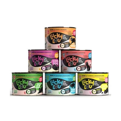 Lucky Lou -kissanruokapurkit, eri makuja: kana, ankka, nauta, villisika, kalkkuna ja lammas. Teksti: The Real Taste!, 96 % meat, näkyvissä englanniksi ja saksaksi.