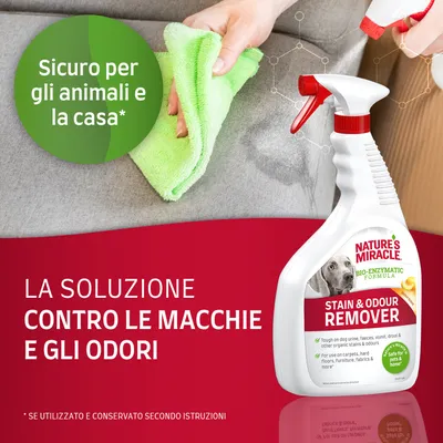 Nature's Miracle Stain & Odour Remover, flacone spray su divano con mano che pulisce. Testo: Sicuro per gli animali e la casa. La soluzione contro le macchie e gli odori.