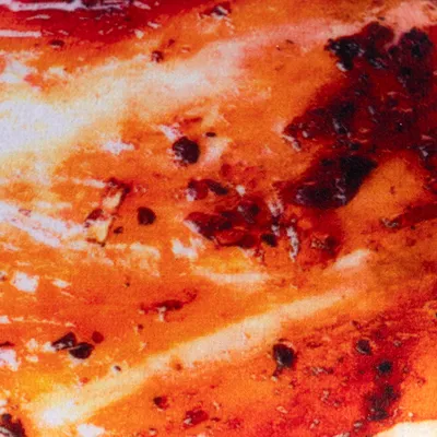 Close-up of a baked bone with brown and red roasted aromas, no further information visible.