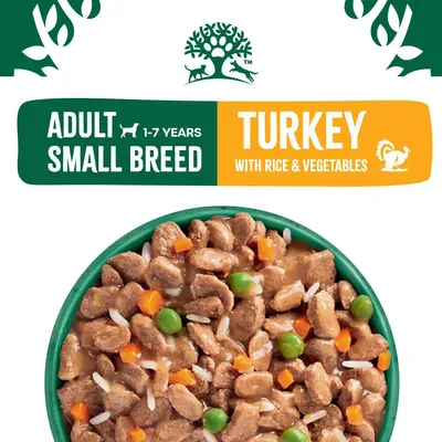 Adult small breed, 1-7 years. Turkey with rice and vegetables. Image shows chunks of food with peas, carrots, and rice in a bowl.