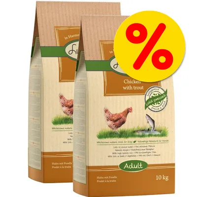 Two 10kg bags labelled 'Chicken with trout, Adult, cold-pressed' with a large yellow percentage discount symbol in the corner, indicating a special offer on this product. Two 10kg bags labelled 'Chicken with trout, Adult, cold-pressed' with a large yellow percentage discount symbol in the corner, indicating a special offer on this product.