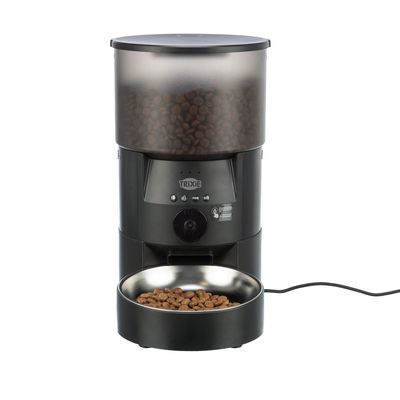 Trixie distributore automatico di cibo con design nero, contenitore trasparente per crocchette e ciotola in acciaio inox. Controllo elettronico visibile.
