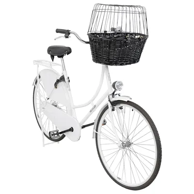 Vélo blanc avec panier en osier noir et grille de protection fixé au guidon, porte-bagages arrière, phare avant visible. Aucun animal ni marque apparente.