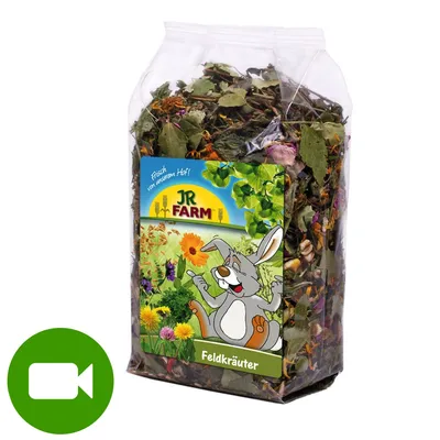 Opakowanie JR Farm Feldkräuter z mieszanką suszonych ziół, widoczny rysunek królika na etykiecie. Zielona ikona kamery w lewym dolnym rogu.