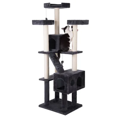 Cat tree with multiple levels, caves and sisal posts. A black and white cat scratches one of the posts. Cat tree with multiple levels, caves and sisal posts. A black and white cat scratches one of the posts.