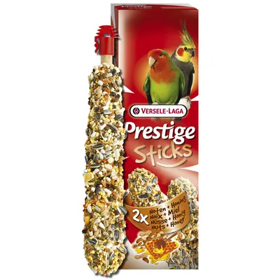 Versele-Laga Prestige Sticks, 2x noix et miel, emballage avec deux oiseaux, mélange de graines visibles sur le stick. Texte multilingue : Noix + Miel, Nuts + Honey, Nüsse + Honig.