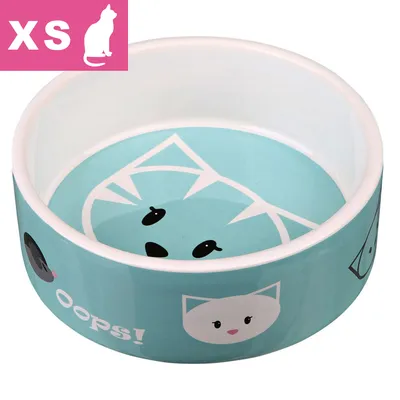 Katteskål i keramik med blå baggrund, katteansigter og teksten 'OOPS!' på siden. Øverst til venstre står XS og en hvid kattefigur.