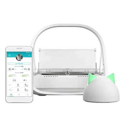 Automatic feeder with smartphone app display for feeding data. White dispenser with transparent lid and green illuminated cat ear design.