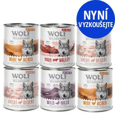 Šest konzerv Wolf of Wilderness: Wide Acres, High Valley, Great Desert, Wild Hills. Modrý kruh s textem NYNÍ VYZKOUŠEJTE.