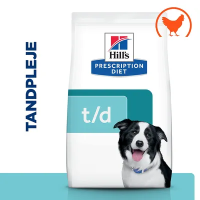 Hill's Prescription Diet t/d hundefoder, billede af sort-hvid hund, teksten TANDPLEJE og et orange kyllingesymbol øverst til højre på posen.