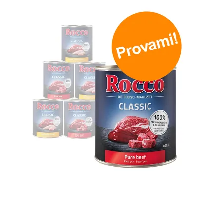 Scatole di cibo per cani Rocco Classic, visibile variante Pure beef 800 g. Etichetta: 100% fresh ingredients & grain-free. Bollino arancione con testo: Provami!