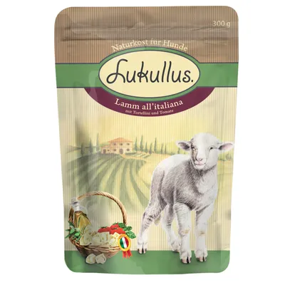 Lukullus Lamm all’italiana mit Tortellini und Tomate, Naturkost für Hunde, 300 g. Pakkauksessa lammas ja vihanneksia korissa, taustalla maaseutumaisema.