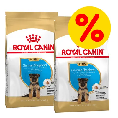 Dos sacos de Royal Canin German Shepherd Puppy con símbolo de porcentaje en círculo amarillo, indicando posible oferta o descuento visible en la imagen.