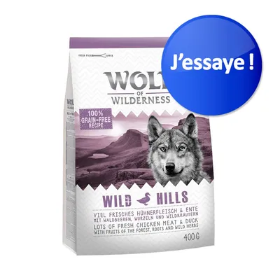Sac Wolf of Wilderness Wild Hills 400 g, mention «100% grain-free recipe», texte «J’essaie !» sur un cercle bleu, canard visible, poulet et canard frais indiqués en anglais.
