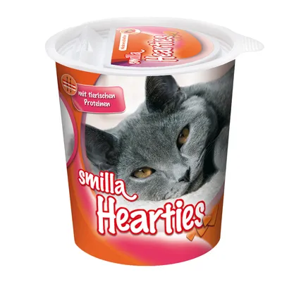 Ambalaj Smilla Hearties cu imagine de pisică și text vizibil: „mit tierischen Proteinen”. Recipient rotund cu capac, design portocaliu-roșu.