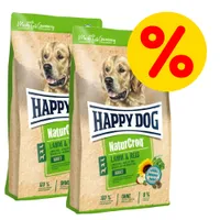 Due confezioni di crocchette Happy Dog NaturCroq Lamm & Reis Adult con simbolo percentuale rosso su sfondo giallo, offerta visibile sulla confezione.