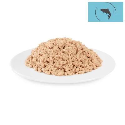 Light, shredded fish on a white plate. Fish symbol on blue background in the top right.