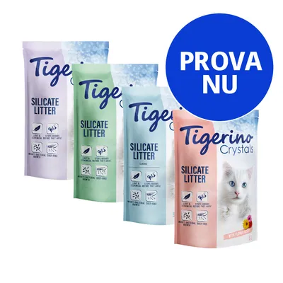 Fyra påsar Tigerino Silicate Litter kattsand, olika färger och varianter. Text: PROVA NU i blå cirkel. En påse visar en vit katt och texten Crystals with flower scent 5L.