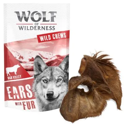 Wolf of Wilderness Wild Chews Ears with Fur -pussi, jossa susi ja lehmäkuva sekä kaksi karvaista korvaa tuotteen edessä. Teksti: High Valley, Ears with Fur.