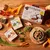Forthglade senior grain free variety pack with turkey and lamb, showing packaging, food cubes in a bowl, peas, carrots, butternut squash and natural ingredients on a wooden table.