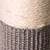 Close-up of a scratching post trunk with sisal rope and grey fabric cover.