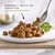 Assiette de bouchées en sauce avec fourchette, texte visible : GOURMET™ GOLD LES NOISETTES, brin de persil à côté. Marque et nom du produit clairement affichés.