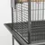 Vue rapprochée d’une cage en métal noir avec barreaux, plateau inférieur amovible et perchoir en bois visible à l’intérieur.