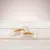 Two chew bones with dried meat filling on a light wooden table.