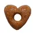 Crocchetta a forma di cuore con foro centrale, superficie marrone e consistenza compatta visibile. Nessun marchio o testo presente.