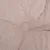 Gros plan sur un tissu beige à texture tissée, avec un bouton central visible. Matériau textile uniquement, aucun autre élément n’est montré.