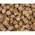Close-up of compressed brown feed pellets with visible plant fibres and grains, showing texture and ingredients for assessing product quality.
