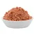 Bowl with red, moist pet food, visible with small pieces and green accents.