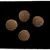 Four round brown dry food kibbles shown on a black background to display shape and size.