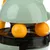 Toy with green casing and two yellow balls, suitable for interactive play.