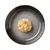 Close-up of a portion of wet food with vegetables and meat on a grey plate.