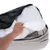 Hand showing removable cover of a pet bed with zip and removable inner cushion.