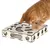 Chat roux posant une patte sur un jouet en bois carré avec plusieurs ouvertures de formes variées (cœur, cercle, losange).