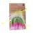 TIAKI Rainbow Monster gioco in peluche con pelliccia gialla, verde e rosa e due occhi. Confezione con informazioni sul prodotto sullo sfondo.