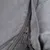 Close-up of a grey zip on a fabric cover, showing the material's detailed workmanship.