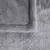 Close-up of grey, soft plush material with visible seams. Suitable for pet beds or blankets.