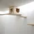 Cube mural en bois clair avec ouvertures en forme de tête de chat, pont suspendu et deux étagères murales assorties, système d’escalade pour chats visible.