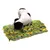 Hond met zwart-witte vacht snuffelt op een snuffelmat van stof in groen, geel en grijs. Mat met veel losse stroken zichtbaar.