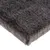 Close-up of a dark grey, rectangular mat with a soft, furry fabric surface. Material and texture are clearly visible.