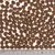 Close-up of brown, round dry food pieces with a ruler below for size indication in centimetres.