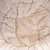 Close-up of beige, soft plush material with padded seams, suitable for cosy surfaces or upholstery.