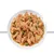 Chunks of brown meat with green pieces in gravy on a white plate, shown close up. No visible packaging or branding.