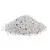 Pile of white and grey granules with scattered black particles, possibly cat litter.