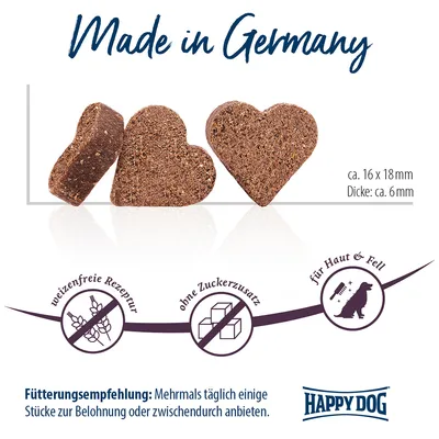 Made in Germany, Happy Dog. Friandises en forme de cœur, env. 16 x 18 mm, épaisseur env. 6 mm. Sans blé, sans sucre ajouté, pour peau et pelage. Texte allemand visible.